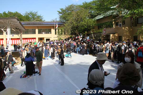 Spectators exiting the sumo arena. Before, spectators had to bring their own picnic mats to sit on. Now they provided a mat over the entire ground 
Keywords: tokyo Chiyoda-ku Yasukuni Shrine sumo